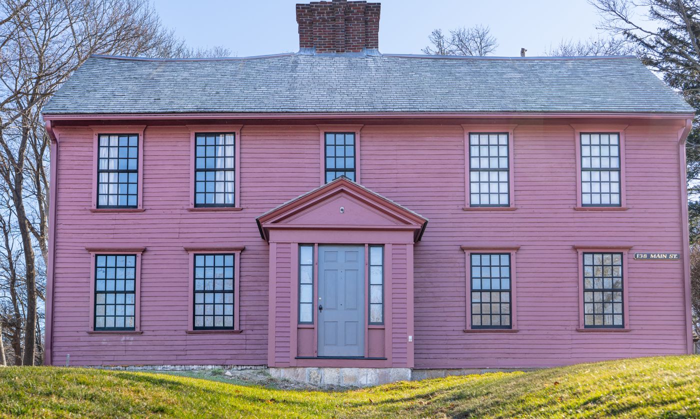 Historic New England colonial house in sound condition on a village main street