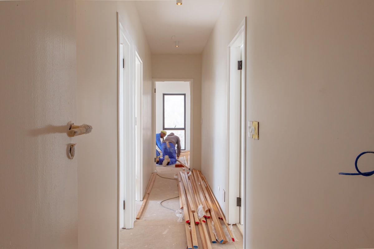 Two carpenters framing interior walls during a residential renovation